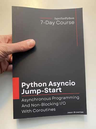 Photo of me holding the paperback version of "Python Asyncio Jump-start".